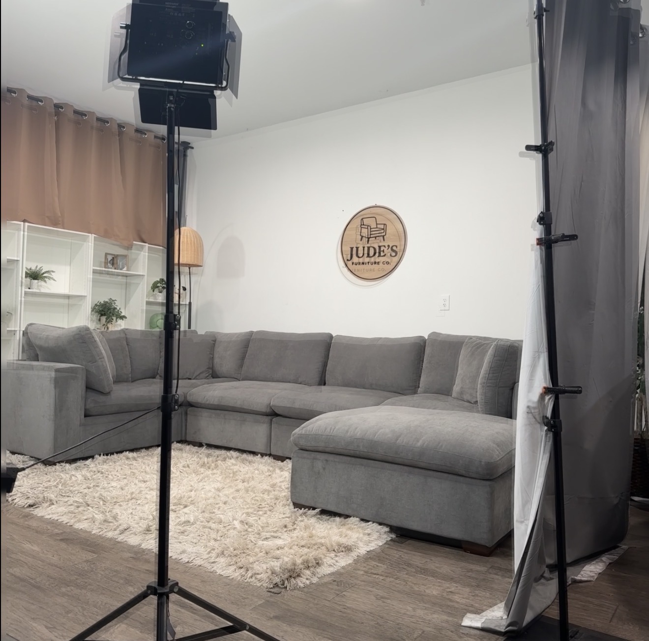 A gray sectional staged with photography lights in the first warehouse